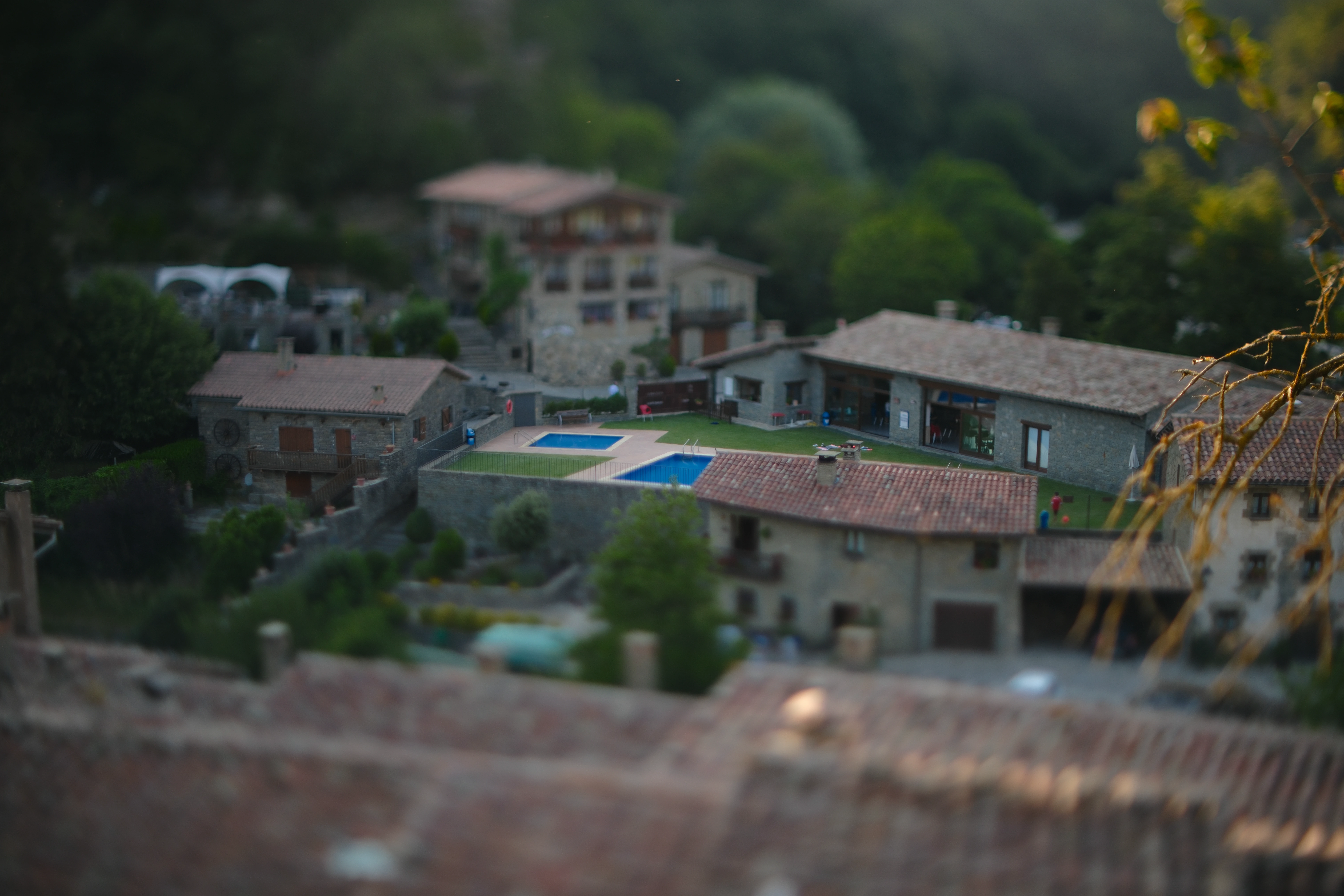Houses and a swimming pool in Rupit compressed by selective focus